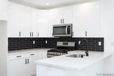 a kitchen with granite countertop a sink and a stove