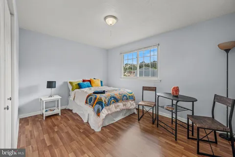 a bedroom with a bed and a desk