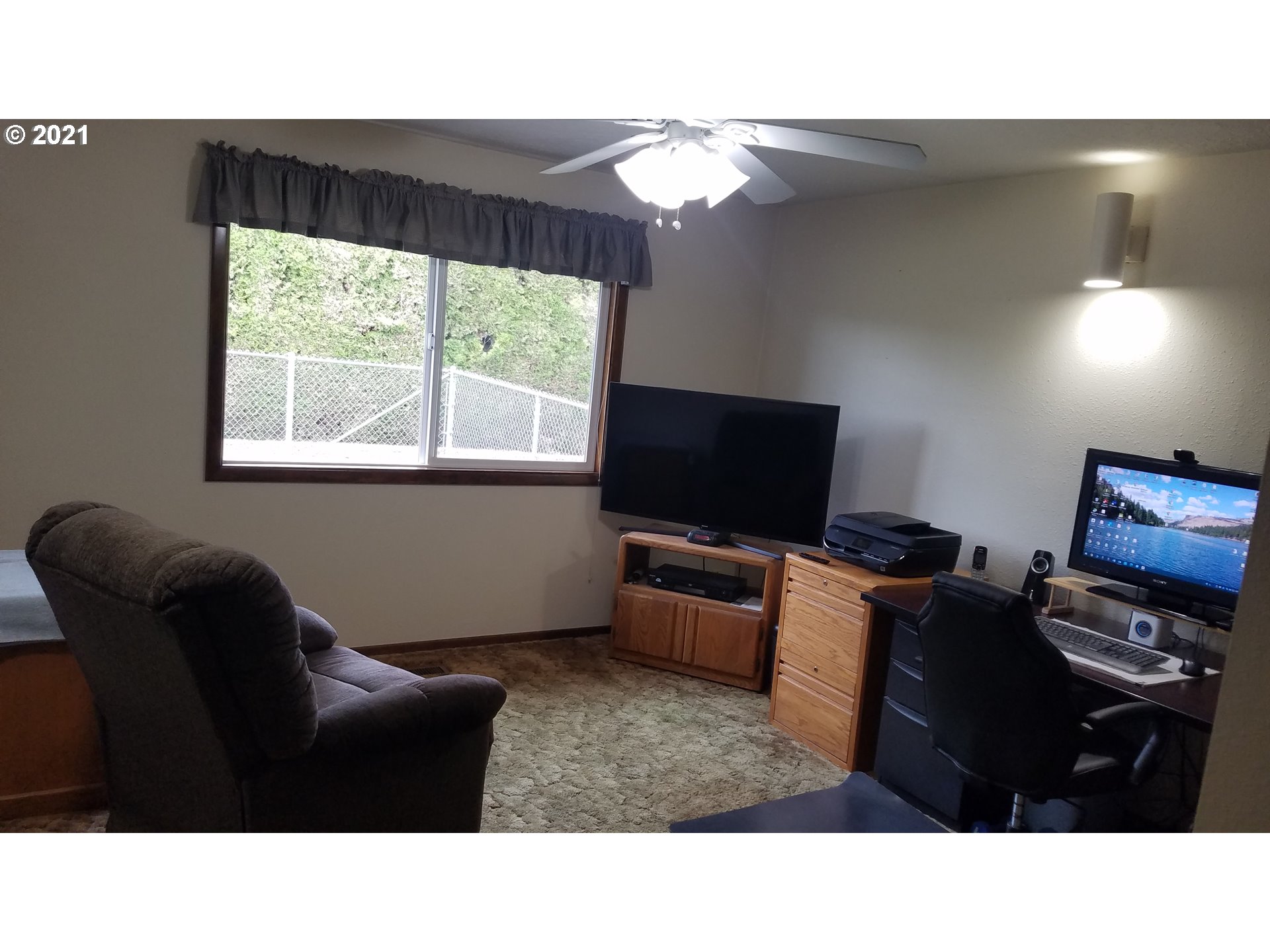 9657 South Kraxberger Road Canby, OR 97013 - Photo 15 of 32 a living room with furniture and a flat screen tv
