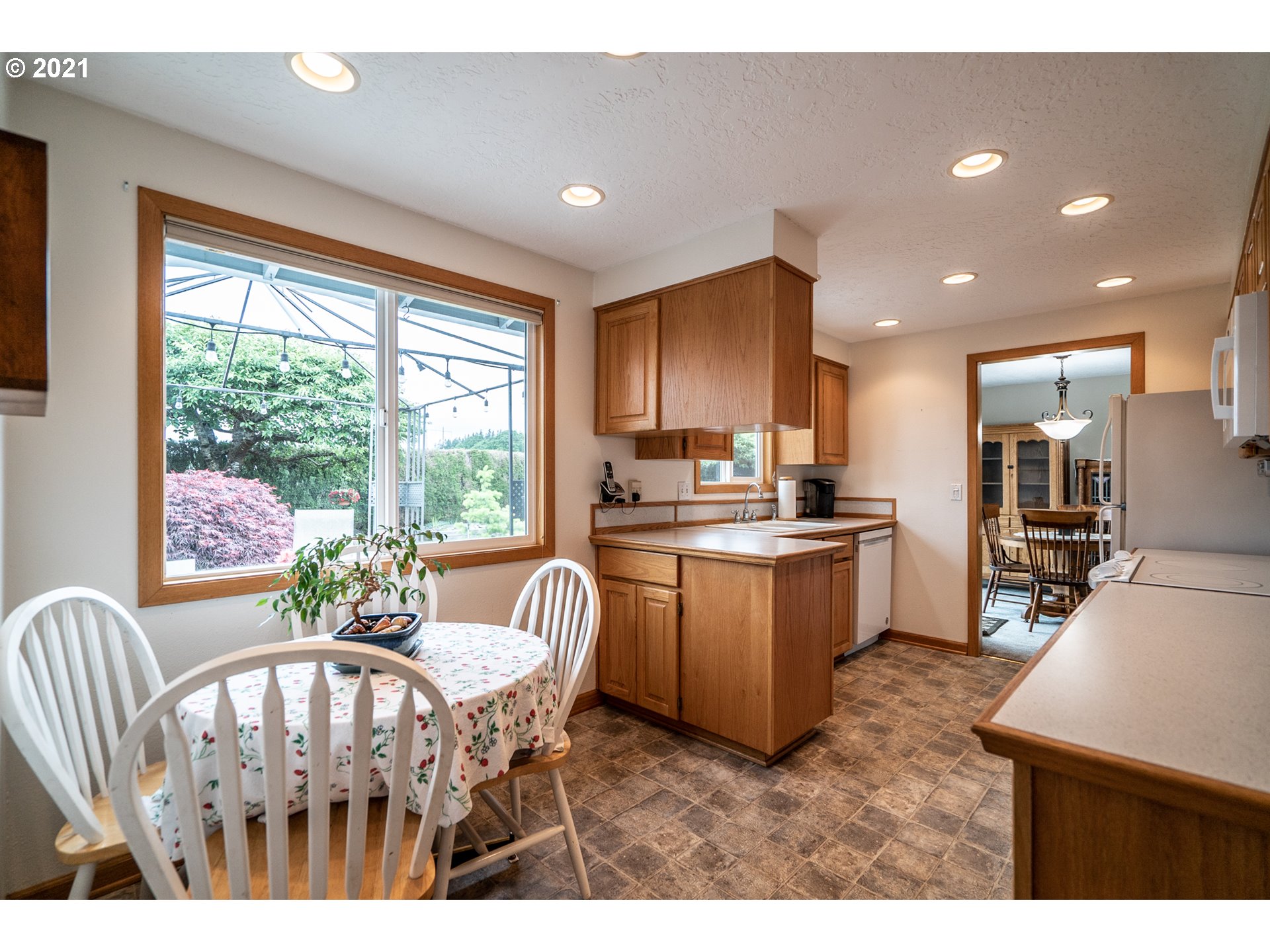 9657 South Kraxberger Road Canby, OR 97013 - Photo 19 of 32 a living room with furniture a kitchen island with furniture wooden floor and a large window