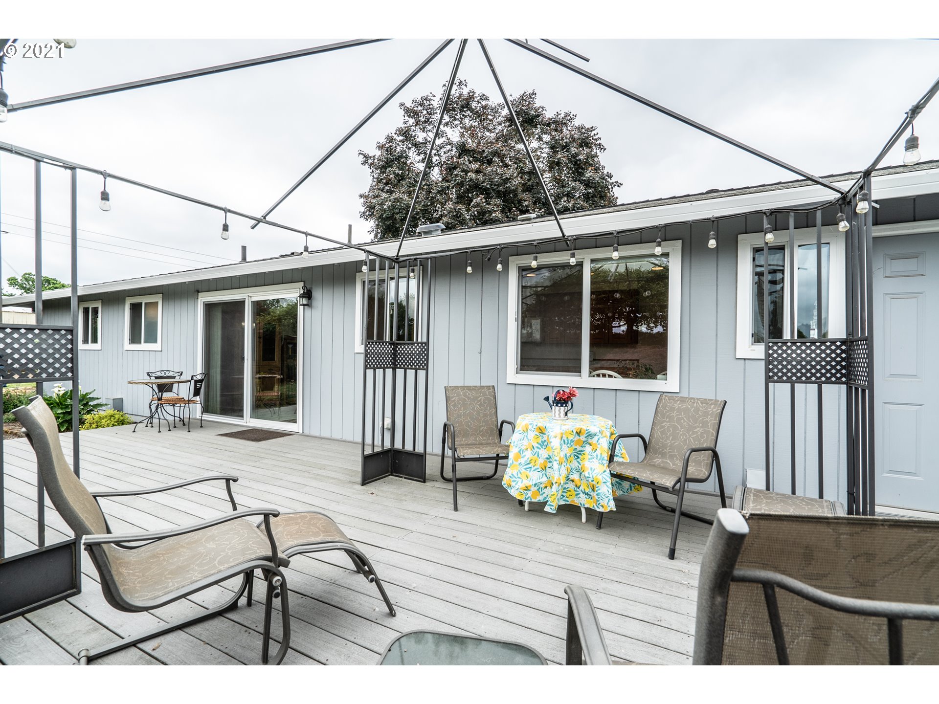 9657 South Kraxberger Road Canby, OR 97013 - Photo 23 of 32 a view of a patio with couches chairs and potted plants