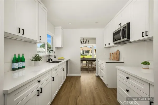 a kitchen with a sink a microwave a stove and refrigerator