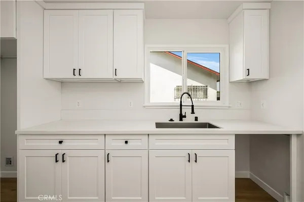 a kitchen with a sink and cabinets