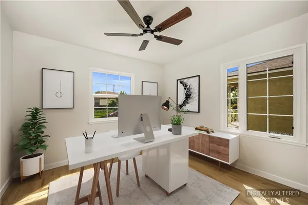 a living room with furniture a window and a potted plant