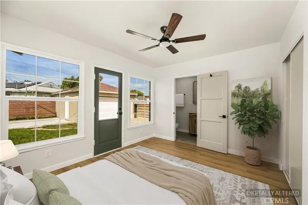 a bedroom with a bed and a large window