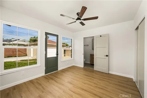 a view of a livingroom with a window and wooden floor