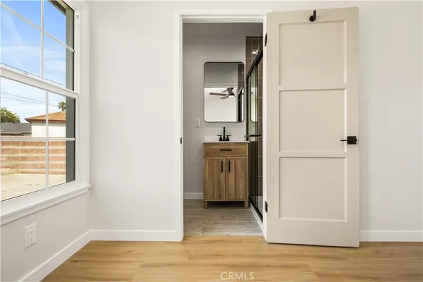 a view of a kitchen from the hallway with a sink and a window