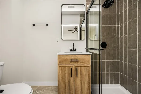 a bathroom with a shower a sink and toilet