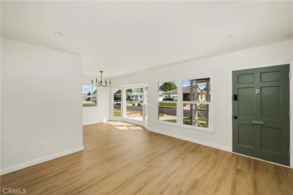 an empty room with wooden floor and door