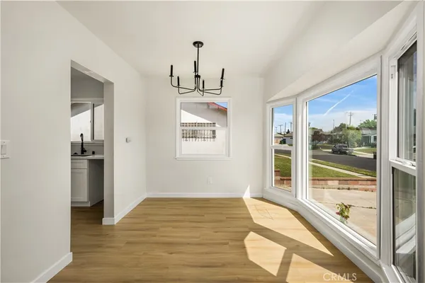 a view of a room with wooden floor and windows