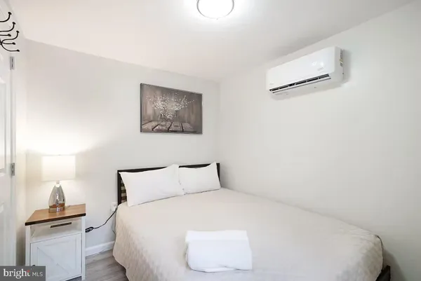 a bedroom with a bed and a lamp on table