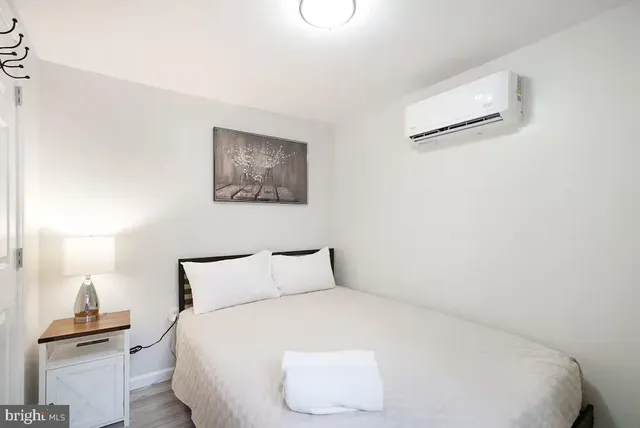 a bedroom with a bed and a lamp on table