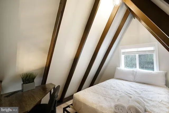 a bedroom with a bed and a window