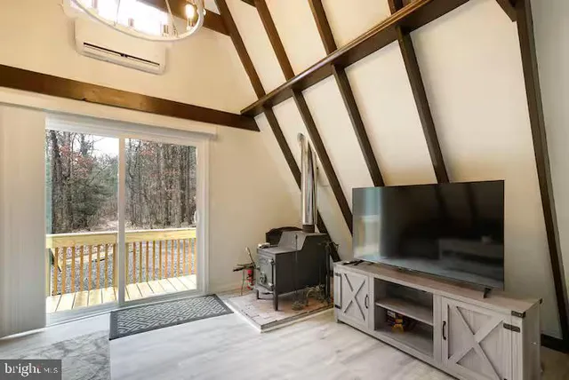 a view of a living room with furniture and windows