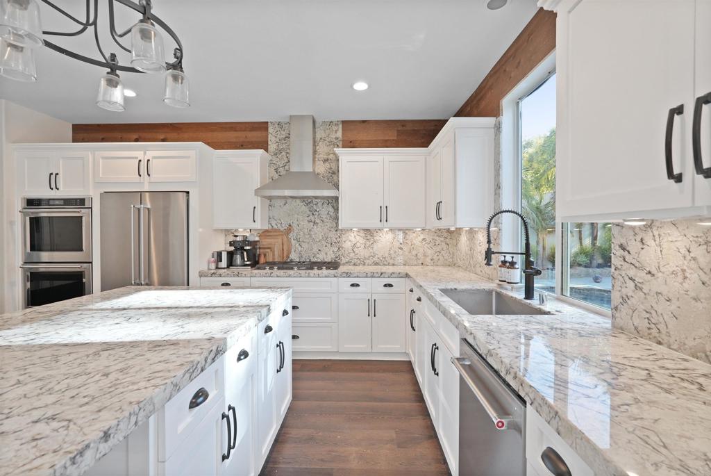 25351 Forest Street Corona, CA 92883 - Photo 17 of 72 a large kitchen with stainless steel appliances granite countertop a sink stove and refrigerator