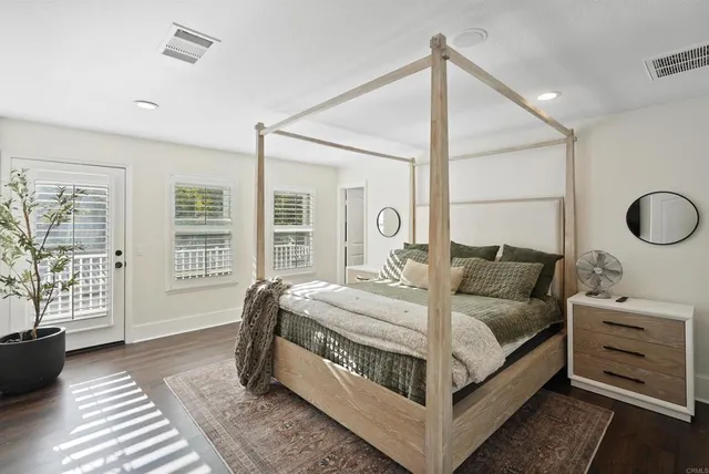 a bathroom with a tub a double vanity sink a vanity a window and a mirror