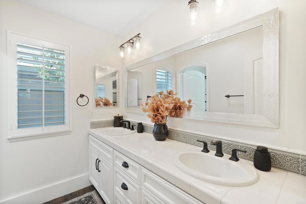 25351 Forest Street Corona, CA 92883 - Photo 36 of 72 a bathroom with a double vanity sink window and a mirror