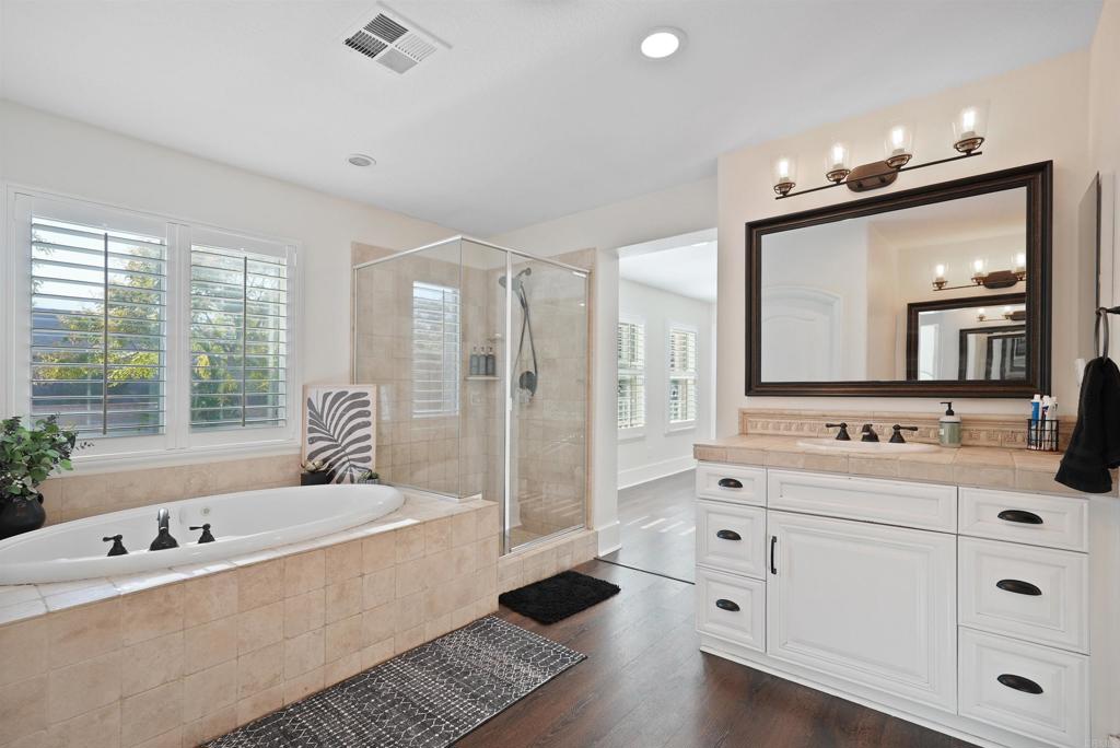 25351 Forest Street Corona, CA 92883 - Photo 38 of 72 a bathroom with a tub a double vanity sink a vanity a window and a mirror