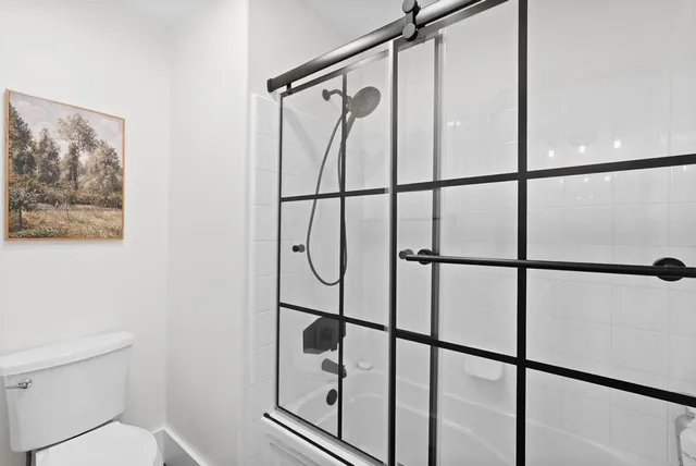 a view of a patio with table and chairs and floor to ceiling window