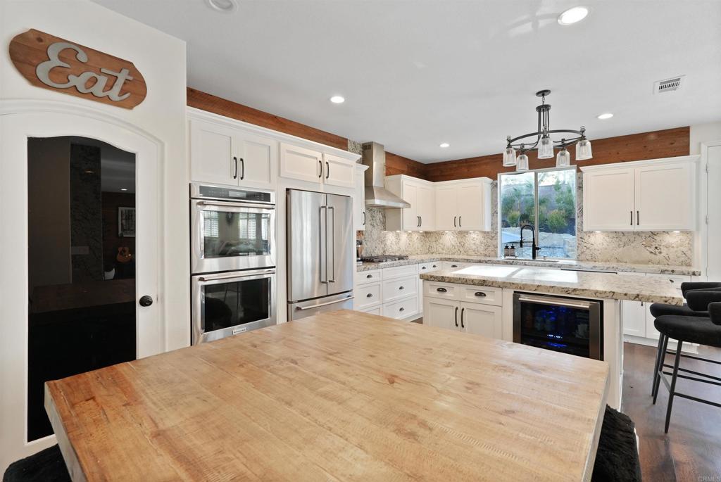25351 Forest Street Corona, CA 92883 - Photo 8 of 72 a kitchen with granite countertop a refrigerator stove top oven and sink