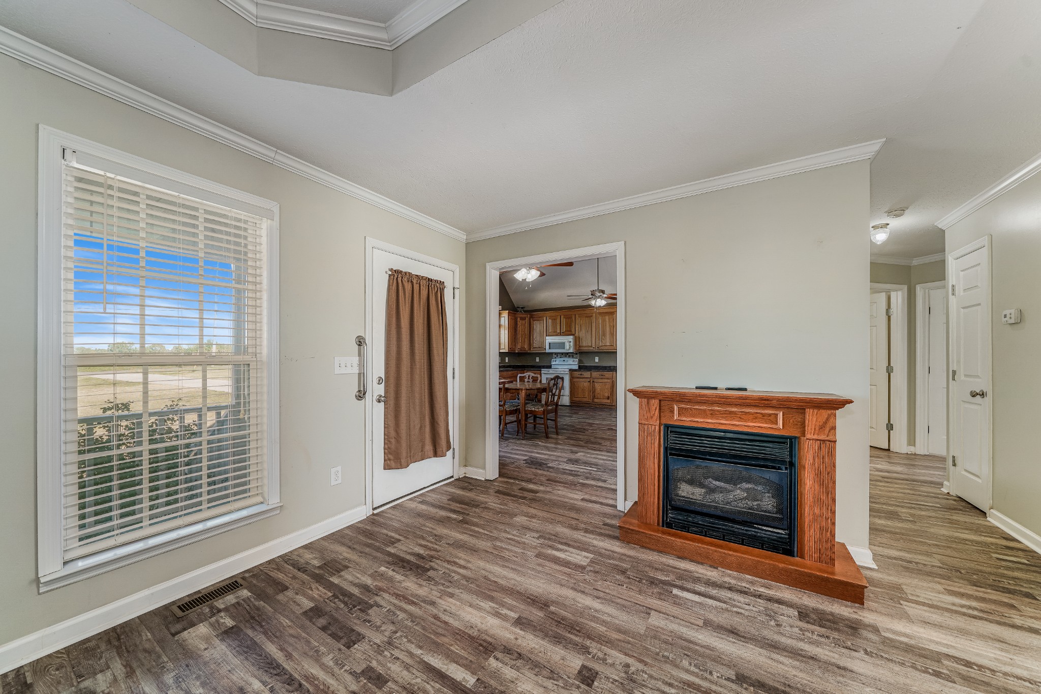 185 Patrick Road Fayetteville, TN 37334 - Photo 5 of 28 a view of an empty room with wooden floor fireplace and a window