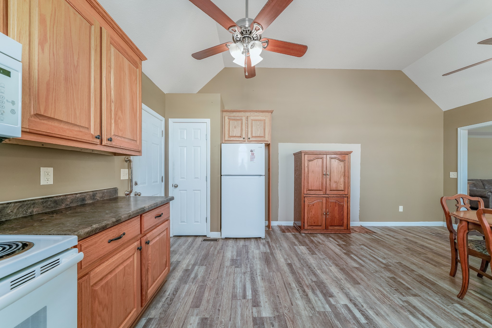 185 Patrick Road Fayetteville, TN 37334 - Photo 10 of 28 a kitchen with a wooden floor and a refrigerator