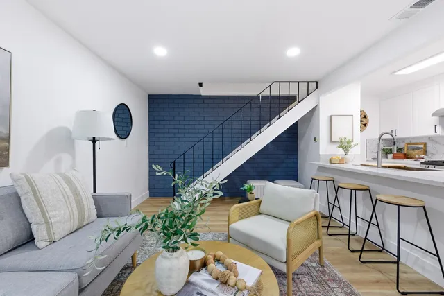 a living room with furniture and flowers