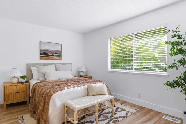 a bedroom with a bed and a window