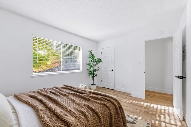 a bedroom with a bed and a window