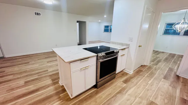 a kitchen with a stove oven and sink