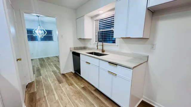 a kitchen with a sink and cabinets