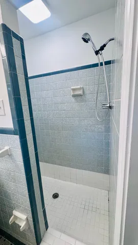 a view of backyard with wooden stairs and a fence