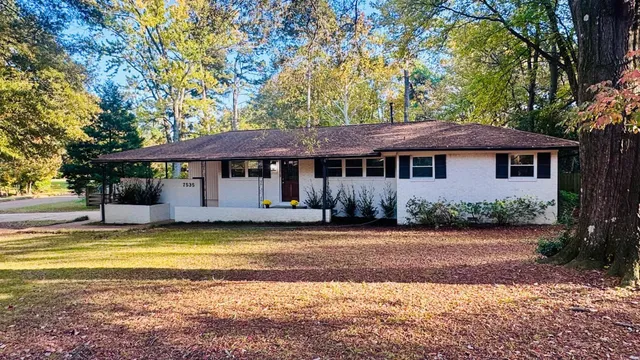 a view of a house with a swimming pool and a yard
