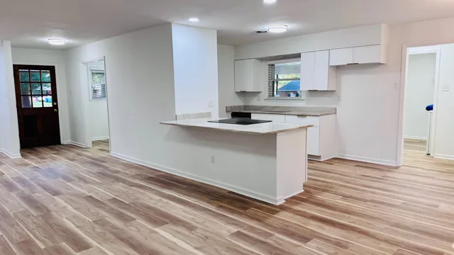 a kitchen with sink a microwave and stove
