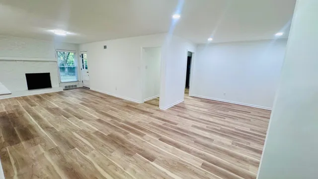 a view of a hallway with stainless steel appliances