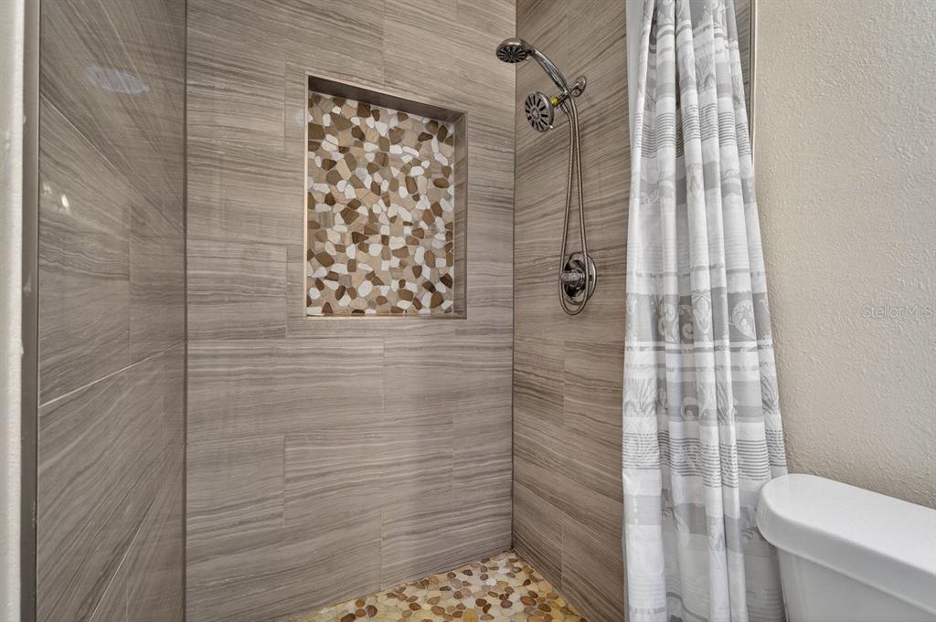 450 Lambert Avenue Flagler Beach, FL 32136 - Photo 12 of 41 a bathroom with a toilet and shower