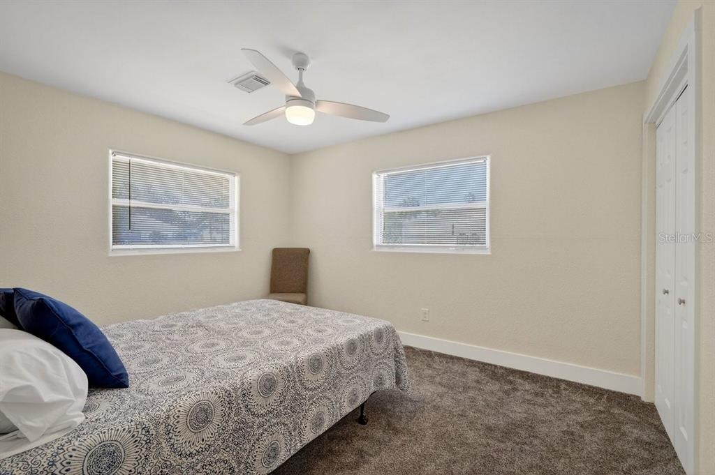 450 Lambert Avenue Flagler Beach, FL 32136 - Photo 13 of 41 a bedroom with a large bed and a window