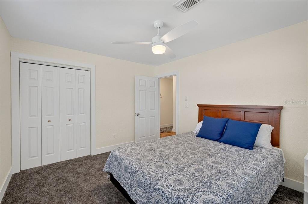 450 Lambert Avenue Flagler Beach, FL 32136 - Photo 14 of 41 a bedroom with a bed and a ceiling fan