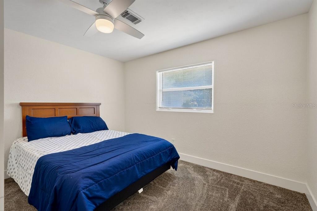 450 Lambert Avenue Flagler Beach, FL 32136 - Photo 15 of 41 a bedroom with a bed and painting on the wall