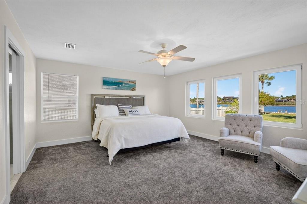 450 Lambert Avenue Flagler Beach, FL 32136 - Photo 17 of 41 a spacious bedroom with a bed and a couch