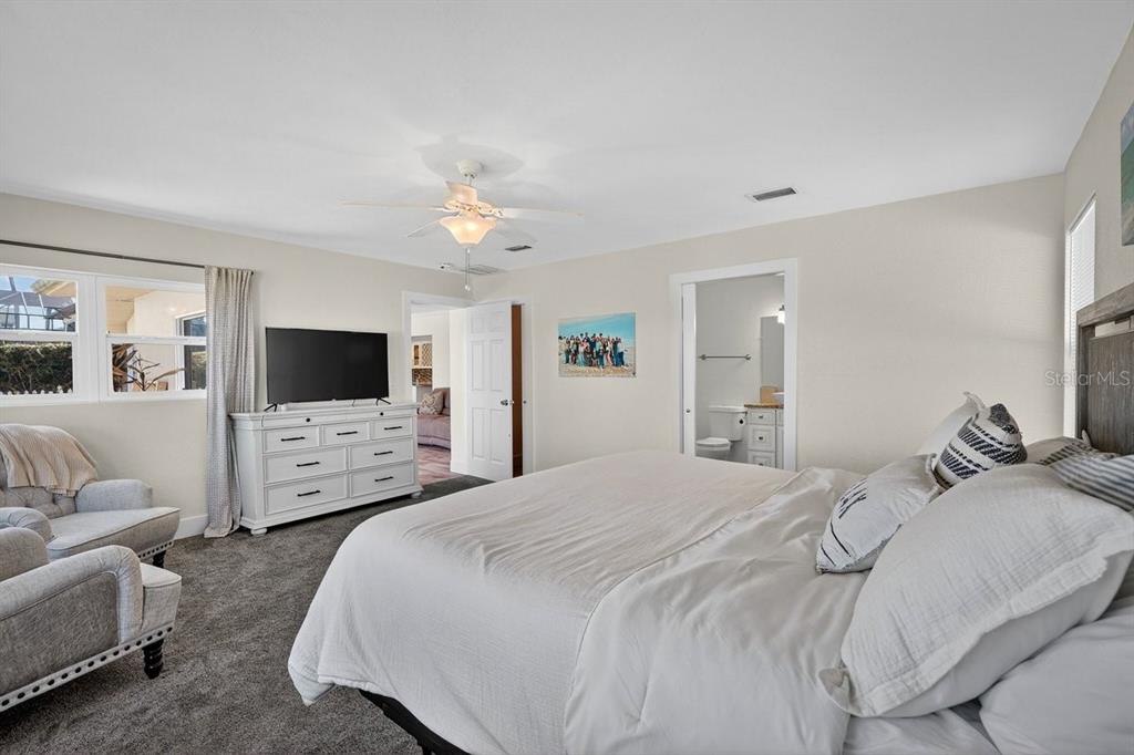 450 Lambert Avenue Flagler Beach, FL 32136 - Photo 19 of 41 a bedroom with a bed and a flat screen tv
