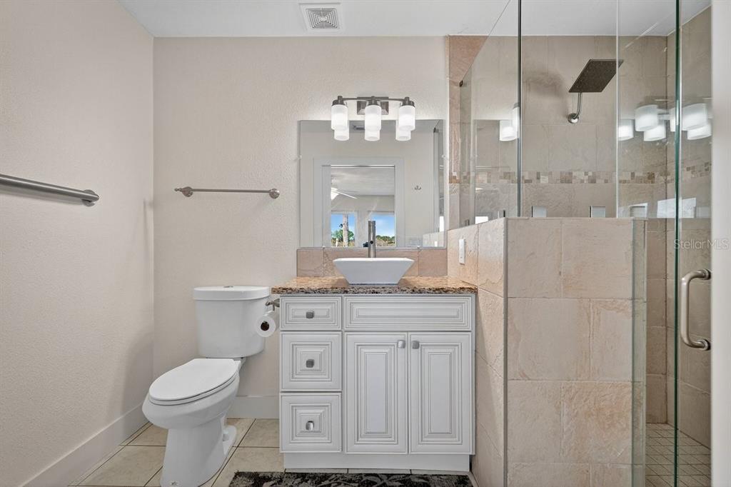 450 Lambert Avenue Flagler Beach, FL 32136 - Photo 20 of 41 a bathroom with a sink a toilet and shower