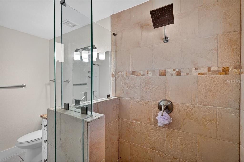 450 Lambert Avenue Flagler Beach, FL 32136 - Photo 22 of 41 a bathroom with a toilet and a shower