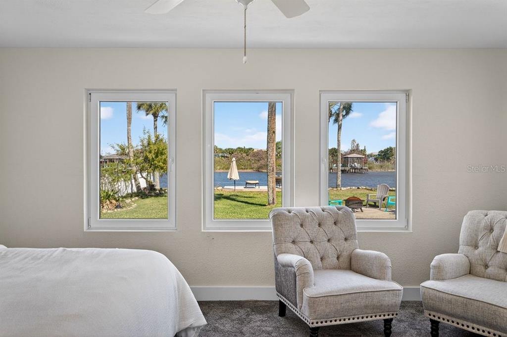 450 Lambert Avenue Flagler Beach, FL 32136 - Photo 25 of 41 a bedroom with furniture and a window
