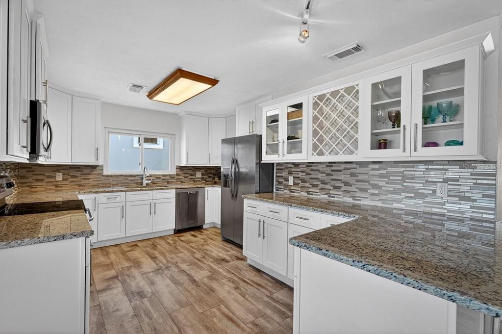 450 Lambert Avenue Flagler Beach, FL 32136 - Photo 29 of 41 a kitchen that has a sink and a stove in it