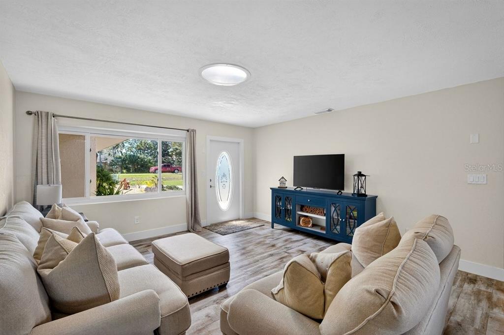 450 Lambert Avenue Flagler Beach, FL 32136 - Photo 7 of 41 a living room with furniture and a flat screen tv