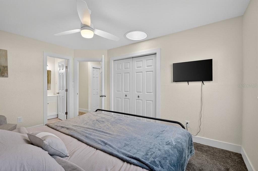 450 Lambert Avenue Flagler Beach, FL 32136 - Photo 10 of 41 a bedroom with a bed and a flat screen tv