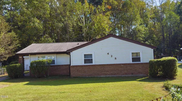 a view of a house with a yard and a garden