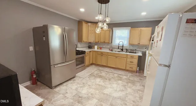 a kitchen with a refrigerator a sink dishwasher a stove and a refrigerator