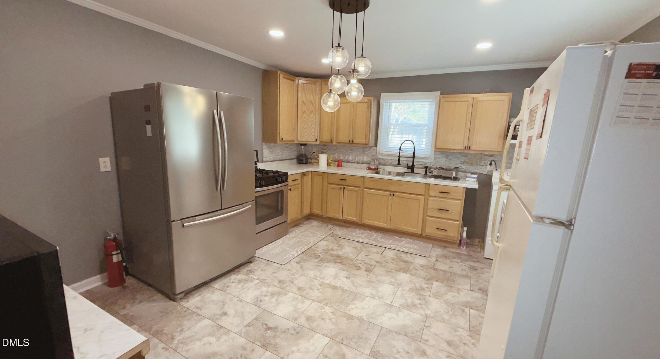 428 Walton Street Durham, NC 27703 - Photo 4 of 14 a kitchen with a refrigerator a sink dishwasher a stove and a refrigerator